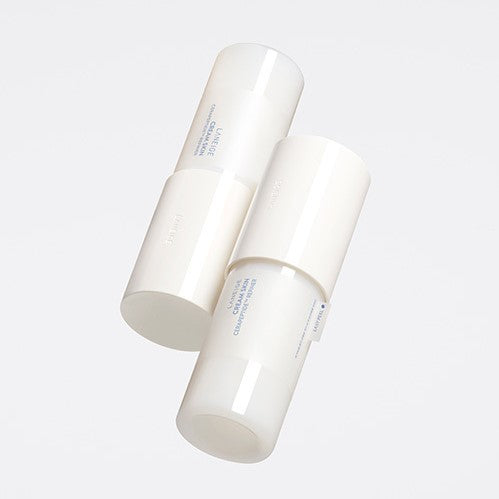 Two cylindrical white containers with minimalistic design and subtle text float against a light grey background. The sleek, modern packaging hints at products designed to promote hydrated skin, possibly featuring nourishing ingredients like ceramides or peptides. The product depicted is the LANEIGE - Cream Skin Cerapeptide Refiner 170ml from the brand LANEIGE.