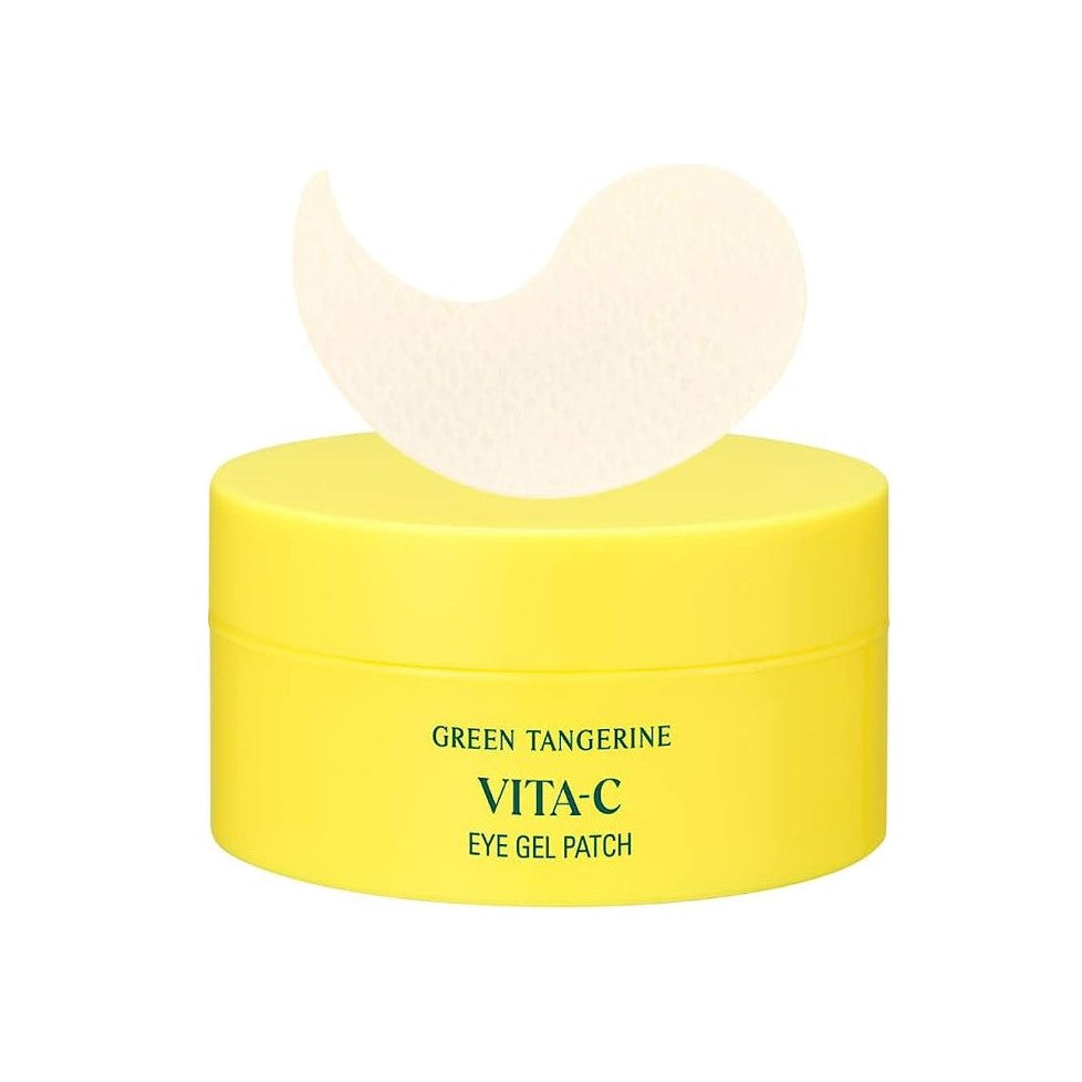 A bright yellow container labeled "GOODAL Green Tangerine VitaC Eye Gel Patch 60ea" sits with a white eye gel patch resting on top, promising 5-minute hydration. The container is simple and clean with green text on a white background, perfect for tackling under eye circles.