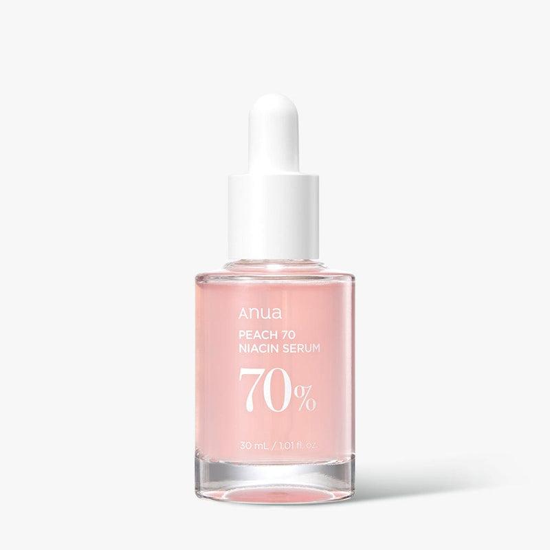 A transparent glass dropper bottle labeled "ANUA Peach 70% Niacinamide Serum 30ml" containing a pink liquid infused with peach extract. The bottle has a white dropper cap and holds 30 ml / 1.01 fl. oz of niacinamide serum designed to achieve glass skin. The background is white.