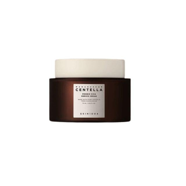 A brown jar of SKIN1004 - Probio-Cica Enrich Cream 50ml with a white label and cap. The label contains text indicating the product name and details about this moisturizing cream, perfect for strengthening the skin barrier. The jar is isolated on a white background.