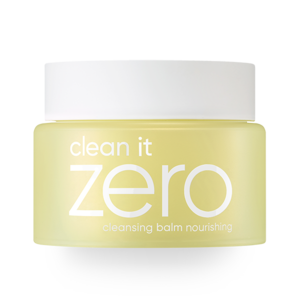 A yellow container of BANILA CO - Clean It Zero Cleansing Balm Nourishing 100ml, specifically designed for nourishing your skin. The product branding features white text on a pale yellow jar with a white lid. This highly effective cleansing balm effortlessly removes even the most stubborn waterproof makeup.