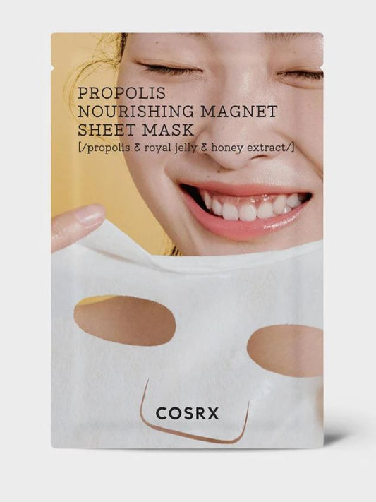 A package of COSRX - Full Fit Propolis Nourishing Magnet Sheet Mask 1ea 25g is shown. The packaging features an image of a smiling person holding the sheet mask close to their face. Text on the package highlights honey-derived ingredients, royal jelly, and propolis for ultimate skin nourishment.