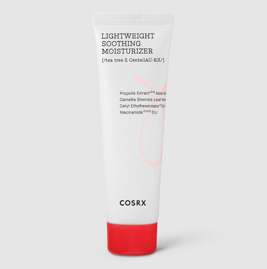 A white squeeze tube labeled "COSRX - AC Collection Lightweight Soothing Moisturiser 80ml" boasts ingredients like tea tree and the Centella AC-Rx Complex, ideal for acne-prone skin. The bottom displays the COSRX brand name in black text, with a bright red cap. The background is plain and light gray.