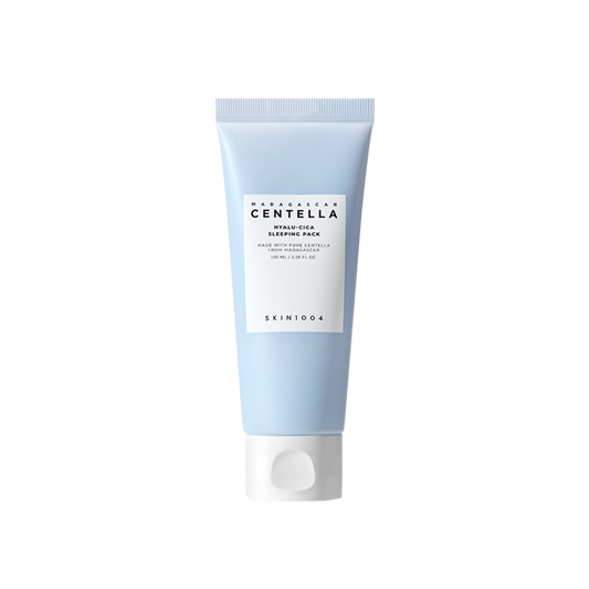 A light blue tube of "SKIN1004" brand’s "SKIN1004 - Madagascar Centella Hyalu-Cica Sleeping Pack 100ml" facing forward. The text on the white label indicates the product contains 3 types of hyaluronic acid and Centella Asiatica. The Hyalu-Cica Formula enhances this sleeping mask, making it a nighttime essential. The tube stands on a white background.