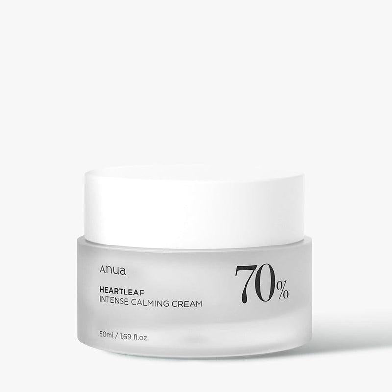 A white and transparent container of ANUA - Heartleaf 70% Intense Calming Cream 50ml is shown against a plain background. The jar, with a white lid, displays text indicating it contains 70% Heartleaf extract known for its anti-inflammatory properties. It also mentions the product volume: 50ml / 1.69 fl. oz.