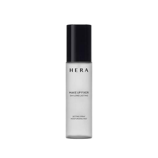 A clear cylindrical bottle with a black cap contains HERA - Make Up Fixer 80ml, perfect for any skincare routine. The label reads "HERA MAKE UP FIXER 24H LONG LASTING SETTING SPRAY MOISTURIZING MIST." The bottle features a minimalist and sleek design, perfect for modern beauty essentials.