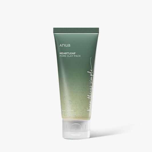 A tube of ANUA - Heartleaf Pore Clay Pack 100ml, enriched with Bentonite, is shown against a white background. The green tube transitions to white at the bottom, with text that reads "ANUA - Heartleaf Pore Clay Pack 100ml" and "Keep things simple." The white cap completes its sleek design.