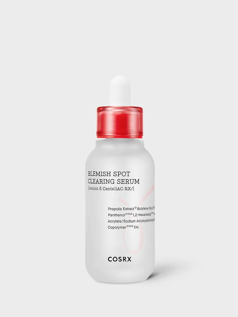 A white bottle of COSRX - AC Collection Blemish Spot Clearing Serum 40ml with a red cap and dropper, perfect for acne treatment. The label lists key ingredients, including Niacinamide, Propolis Extract, Panthenol, and Centella Asiatica. The background is plain and light gray.