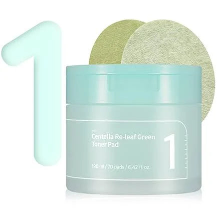 An image of a light blue container labeled "Numbuzin - No.1 Centella Re-Leaf Green Toner Pad 70Pads 190ml," containing 70 Vegan pads and holding 190 ml / 6.42 fl. oz. Enriched with cica extract, it soothes sensitive skin. Two green toner pads are displayed above the container, with a large numeral "1" positioned to the left.
