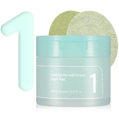 An image of a light blue container labeled "Numbuzin - No.1 Centella Re-Leaf Green Toner Pad 70Pads 190ml," containing 70 Vegan pads and holding 190 ml / 6.42 fl. oz. Enriched with cica extract, it soothes sensitive skin. Two green toner pads are displayed above the container, with a large numeral "1" positioned to the left.
