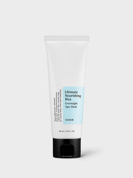 A white tube of COSRX - Ultimate Nourishing Rice Overnight Spa Mask 60ml with a black cap. The front label has product details and a light blue section that reads "Ultimate Nourishing Rice Overnight Spa Mask." This 60 ml (2.02 fl oz) Rice Extract Mask is perfect for nourishing & moisturising your skin overnight.