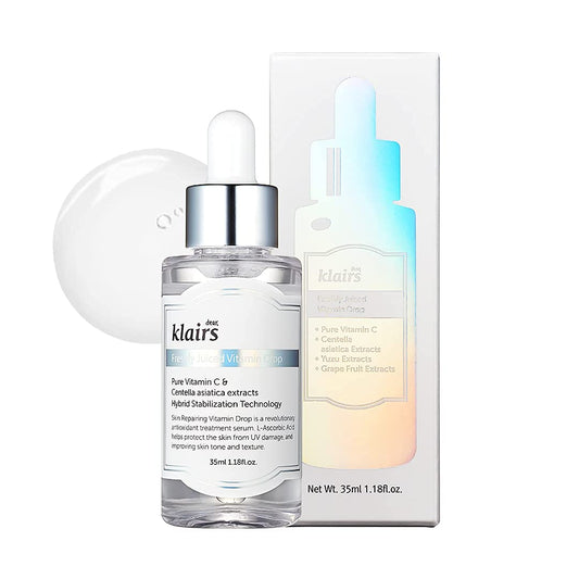 A dropper bottle of KLAIRS - Freshly Juiced Vitamin Drop 35ml is positioned in front of its white packaging box. The bottle's label highlights key ingredients like Vitamin C and Centella Asiatica, ideal for sensitive skin and skin rejuvenation. The product contains 35ml (1.18 fl. oz.) of serum.