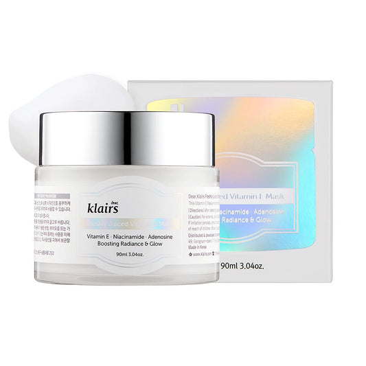 A jar of KLAIRS - Freshly Juiced Vitamin E Mask 90ml stands in front of its holographic box packaging. This multifunctional mask contains 90ml (3.04 oz) and highlights ingredients like antioxidant vitamin E, Niacinamide, and Adenosine for boosting radiance, glow, and skin regeneration.