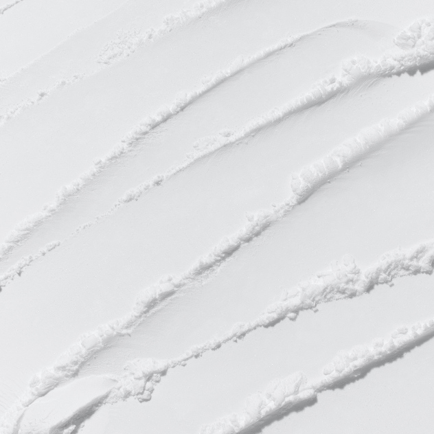 Parallel tracks in the snow, likely from skiing or snowboarding, create a pattern of wavy lines across a pristine snowy landscape. The tracks are evenly spaced and curve smoothly from the top to the bottom of the image, resembling paths on troubled skin smoothed by INNISFREE - No-Sebum AC Powder 5g from INNISFREE.