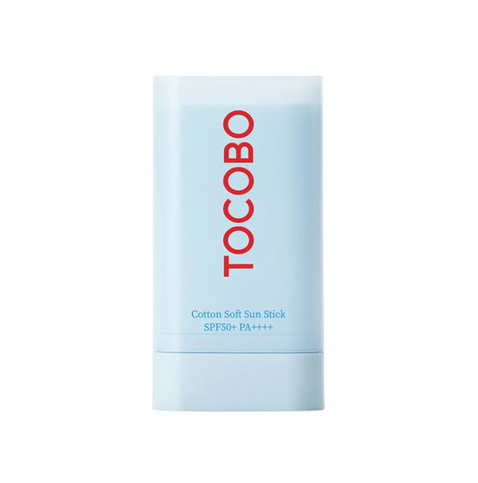 A light blue cylindrical container of TOCOBO - Cotton Soft Sun Stick SPF50+ PA++++ 19g. The brand name "Tocobo" is prominently displayed in bold red letters vertically. This cruelty-free and vegan sun stick features the soothing Herb AC Complex for enhanced skin protection.