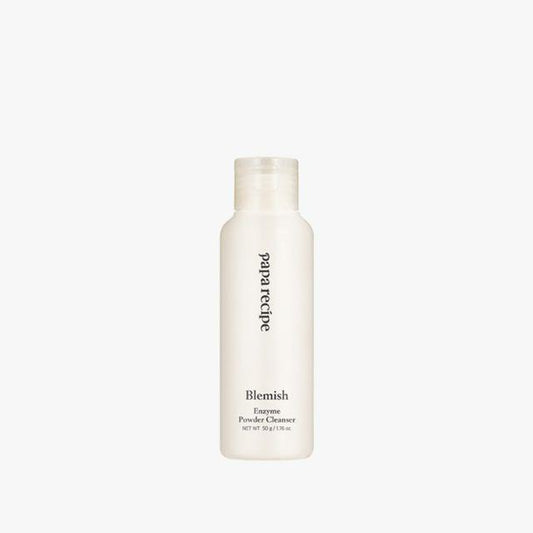 A white cylindrical bottle of PAPA RECIPE - Blemish Enzyme Powder Cleanser 50g with a clear cap. The text on the bottle reads "PAPA RECIPE" and "Blemish Enzyme Powder Cleanser," featuring a PH-balanced formula with rice enzyme for gentle exfoliation. Net Wt 50 g / 1.76 oz. The background is white.