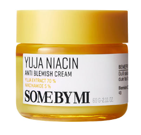 A yellow and white jar of SOME BY MI - Yuja Niacin Anti Blemish Care Cream 60g with 70% yuja extract and 5% niacinamide. The EVE Vegan certified jar features a yellow lid and a white label detailing the product's name and benefits, such as treating dull skin and blemishes. The container is 60g/2.11 oz.